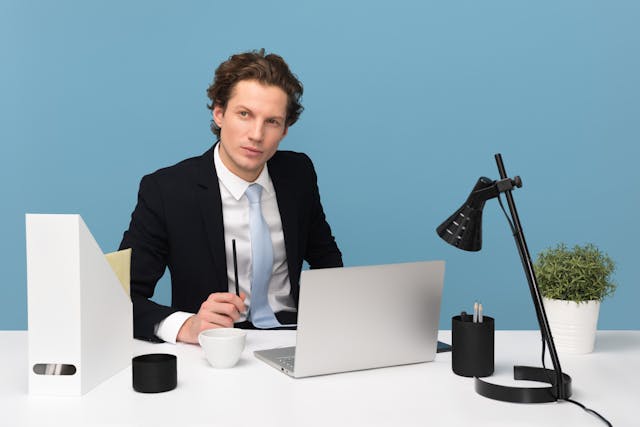 Man advising from behind desk